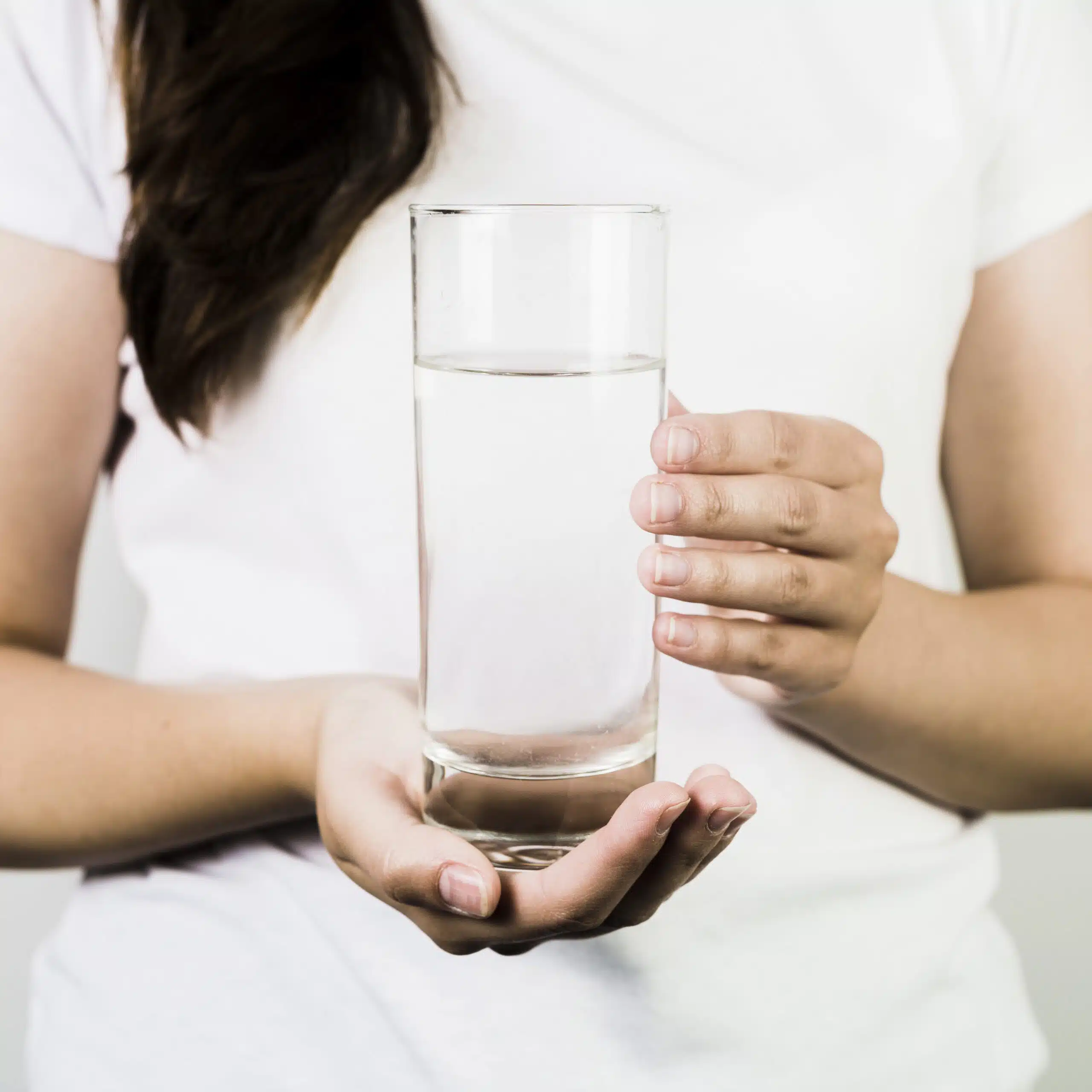 woman holding a glass of water